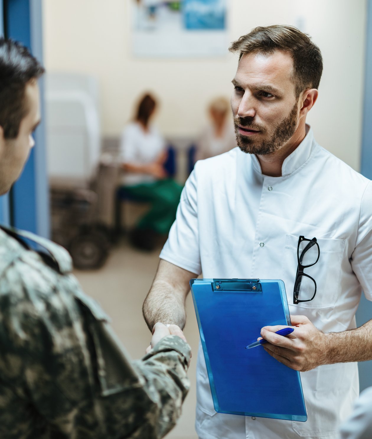 Male Nurse shaking veterans hand
